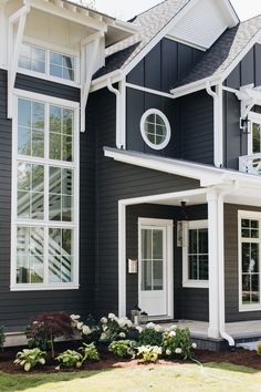 a black house with white trim and windows