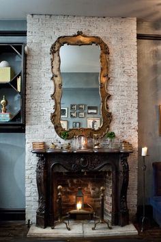 a living room with a fire place and mirror