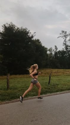 a woman running down the street in shorts