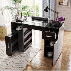 a black and white desk with drawers in front of a window on a wooden floor