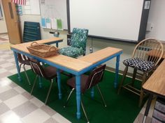 an empty classroom with chairs and desks in front of a whiteboard on the wall