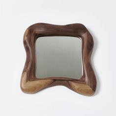 a wooden frame with a mirror on the top and bottom part is made out of wood