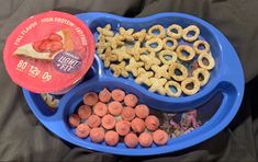 a blue bowl filled with cereal and pretzels