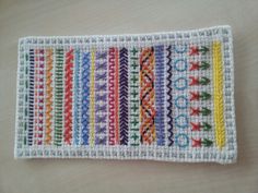 a crocheted placemat with different colored strips on it