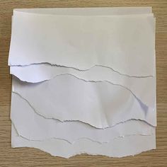 a piece of white paper that has been torn off and is sitting on a table