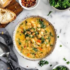 bowls of soup and bread on a marble table