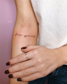 a woman's arm with a small tattoo on it that says, free spirit