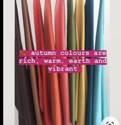 there are many different colors of umbrellas in the vase with text on it that says, autumn colours are rich, warm, earth and vibrant