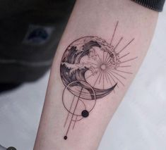 a tattoo on the arm of a person with an abstract wave and sun in it