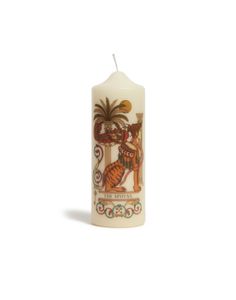 a white candle with an image of a tiger and palm trees on the front side