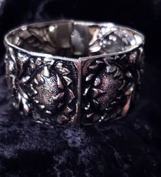 This pretty vintage cuff bracelet is not marked, but it has what looks like SG or SC (Sarah Coventry)scrolled into design by hinge. It has a pretty vintage style patina possibly silver plate as it has not tarnished. It has a dark antiquing that's mostly in recessed areas of the design. This bracelet is 1 3/8 inches thick. It closes completely on a size 7 wrist, and moves around slightly. The condition is great. We ship USPS, usually the next day. Our shop combines shipping and a shipping discoun Vintage Handmade Cuff Bracelet For Formal Occasions, Handmade Vintage Cuff Bracelet For Formal Occasions, Handmade Vintage Cuff Bracelet For Formal Events, Ornate Adjustable Cuff Bracelet For Formal Occasions, Adjustable Victorian Cuff Bracelet For Formal Occasions, Formal Vintage Handmade Cuff Bracelet, Vintage Cuff Bracelet With Intricate Design, Vintage Cuff Bracelet With Intricate Bangle Design, Vintage Bangle Cuff Bracelet With Intricate Design