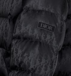 The black technical jacquard down jacket pays tribute to House heritage with a tonal Dior Oblique motif. Both modern and relaxed, it features a two-way zip closure with double pulls, a Dior soft patch on the sleeve and insulating goose down filling. The down jacket will lend a hallmark touch to any outfit.. 52 Cold Pics, Dior Coat, Denim Swimsuit, Dior Jacket, Pretty Sneakers, Designer Jackets For Men, Designer Sportswear, Dior Star, Icon Shoes