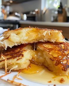 two pieces of french toast on a plate with butter and syrup drizzled over them