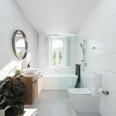 a bathroom with a sink, toilet and bathtub next to a plant in the corner