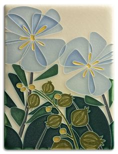 an artistic tile with blue flowers and green leaves