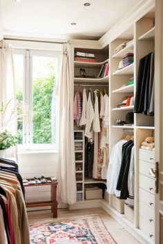 a walk in closet filled with lots of clothes