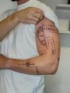 a man with a compass tattoo on his arm