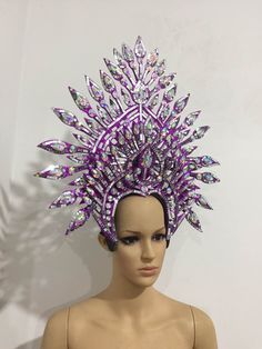 a mannequin wearing a purple headdress with lots of spikes on it