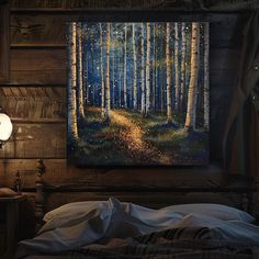 a painting on the wall above a bed in a room with wooden walls and flooring