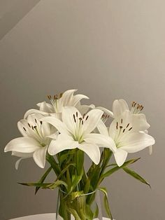 a vase filled with white flowers on top of a table