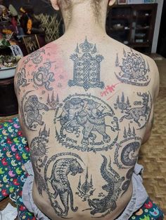 the back of a woman with tattoos on her body