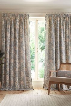 a living room filled with furniture and curtains