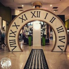 the entrance to an upscale shopping mall with roman numerals and black and white tile