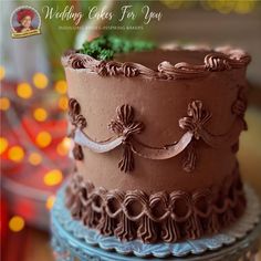 a three layer chocolate wedding cake with frosting flowers and ribbons on the top tier