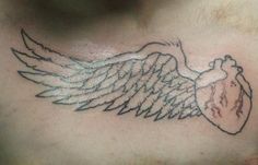 a chest with an angel wing tattoo on it's left side ribcage