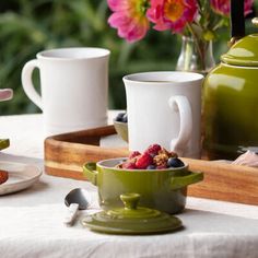 a table topped with plates and cups filled with food