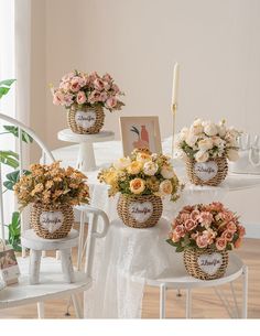 four baskets filled with flowers sitting on top of a table next to a white chair