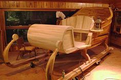 a wooden boat is being worked on in a workshop