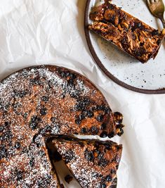 a piece of cake on a plate with a fork next to it and another slice missing