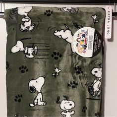 there is a green and white snoopy dog blanket hanging on the wall next to a door