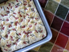 a square pan filled with food on top of a checkered table cloth