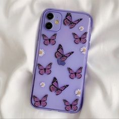 a purple phone case with pink butterflies on it and daisies in the bottom right corner