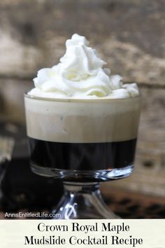 a glass cup filled with whipped cream on top of a table