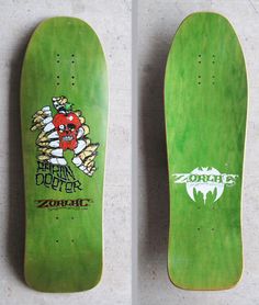 two green skateboards with designs on them