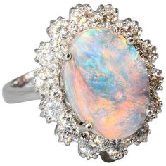 Chic black opal, diamond and 18K white gold dome ring. It features a large oval shaped approx. 4.50 carat black opal as the focal point and flanked by approx. 1.00 carats of high grade round brilliant cut diamonds, all set in 18K white gold. Currently size 6.5, but can be sized slightly up or down. Hallmarks: 18K. Gold Dome Ring, Opal Ring Vintage, Blue Opal Ring, Black Opal Ring, Baguette Diamond Rings, Opal Ring Gold, Engagement Rings Opal, Steampunk Jewelry, 18k Gold Ring