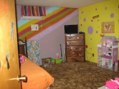 a child's bedroom with colorful walls and furniture