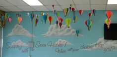 a classroom wall decorated with hot air balloons