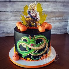 a dragon cake is decorated with oranges and an image of gohan on top