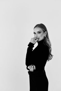 a woman is posing for a black and white photo