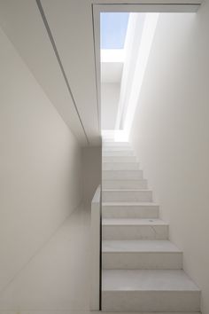 white staircase leading up to the top floor