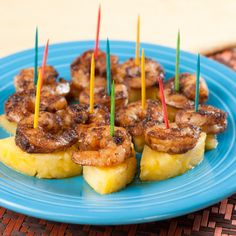 some food is on a blue plate with toothpicks