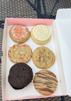 a box filled with lots of different types of cookies