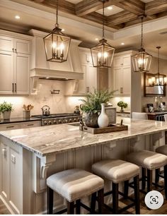 a large kitchen with an island and four stools in front of the counter top