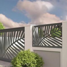 a white fence next to a potted plant in front of a cloudy blue sky