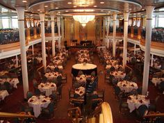 a dining room on a cruise ship with tables and chairs set up for formal dinner