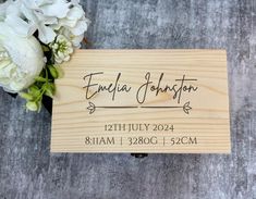 personalized wooden business card with flowers on the front and back side, engraved in black ink